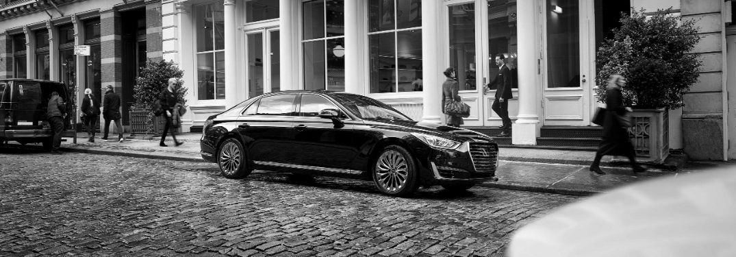 Black and White Photo of Genesis G90 on a Cobblestone Street