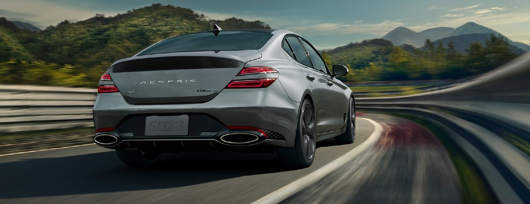 A 2022 Genesis driving along a curvy rural highway.
