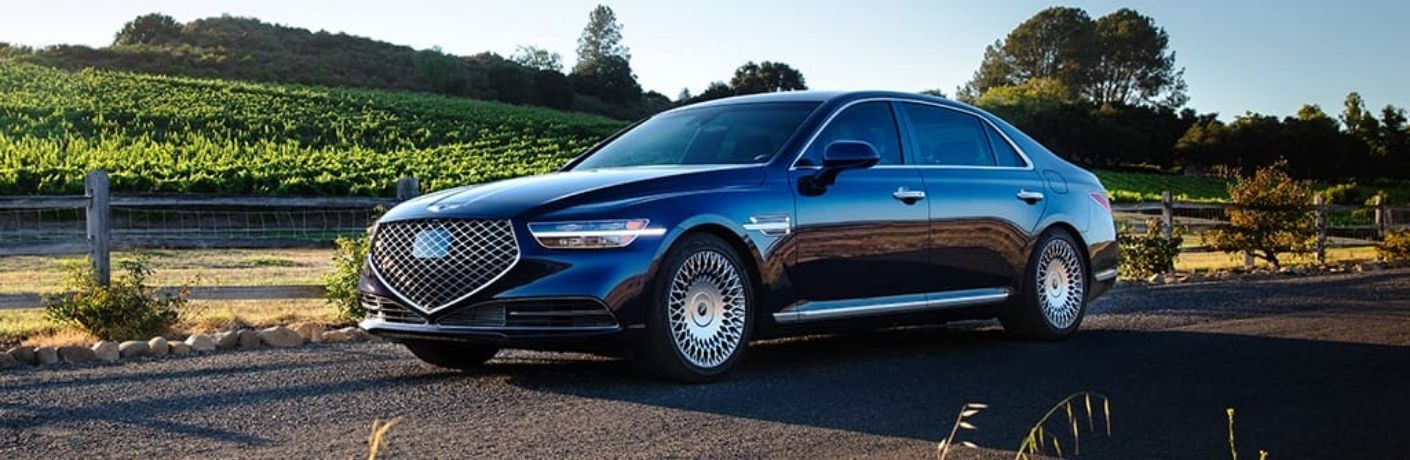Genesis G90 parked on a scenic road.