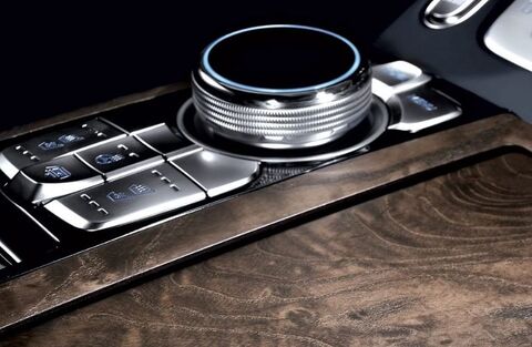 Genesis G90 center console with a rotary dial and buttons.