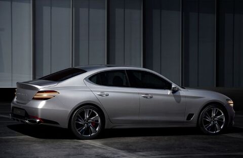 Rear view of a silver Genesis G70 parked in a garage.