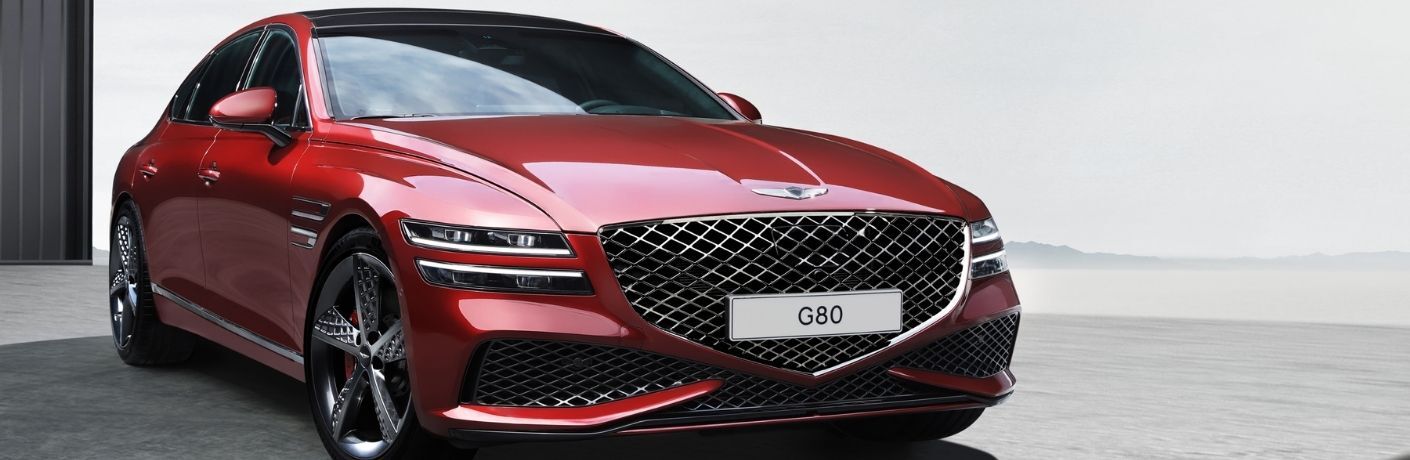 Red Genesis G80 parked in a garage.