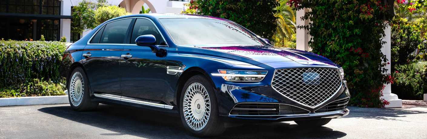 Luxury Genesis G90 parked in a driveway.