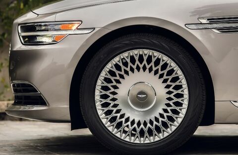 Close-up of a Genesis G90 wheel with a unique spoke design.