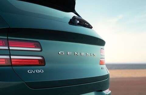 Rear view of a green Genesis GV80 with the "Genesis" logo and "GV80" badge.