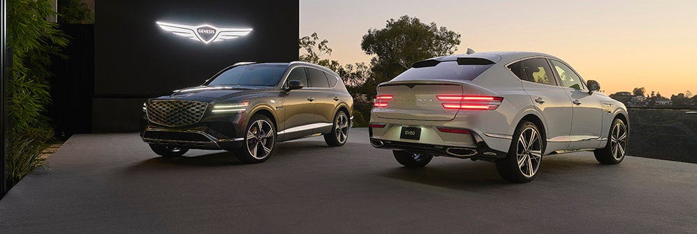 A gray Genesis GV80 and a white Genesis GV70 parked side by side.