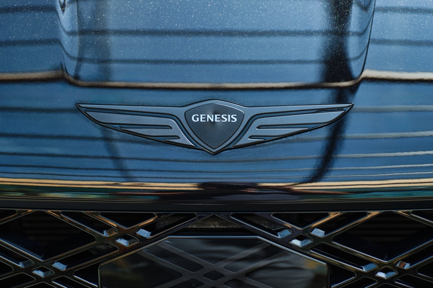 The Genesis logo on the front of the new Genesis sedan is seen close up.