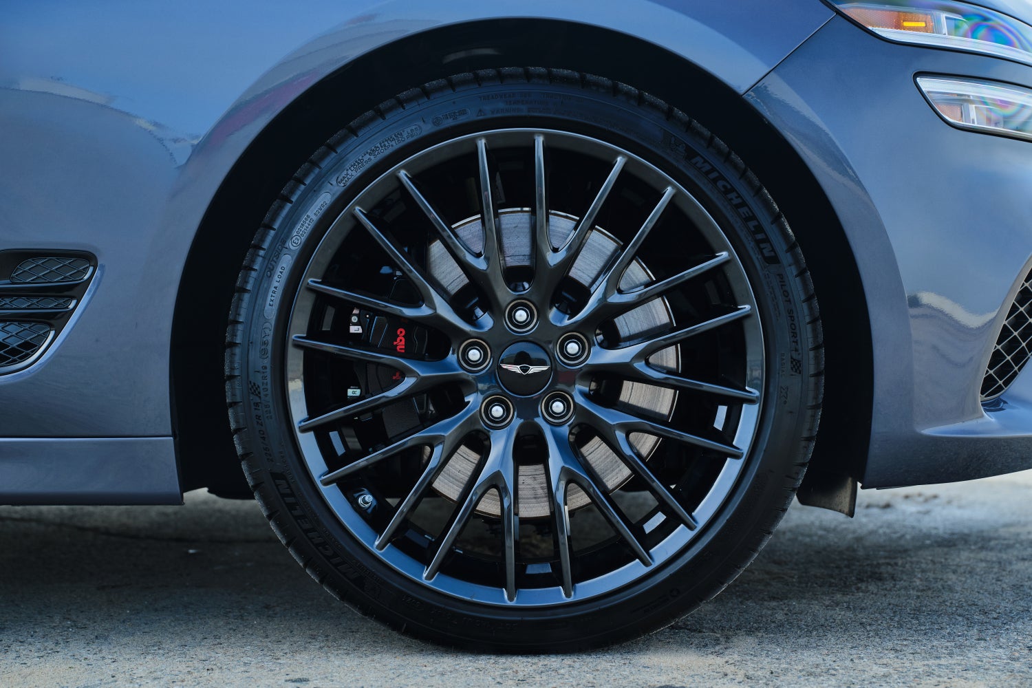 The front driver's side wheel of the 2026 Genesis sedan is seen parked on pavement in Scottsdale.