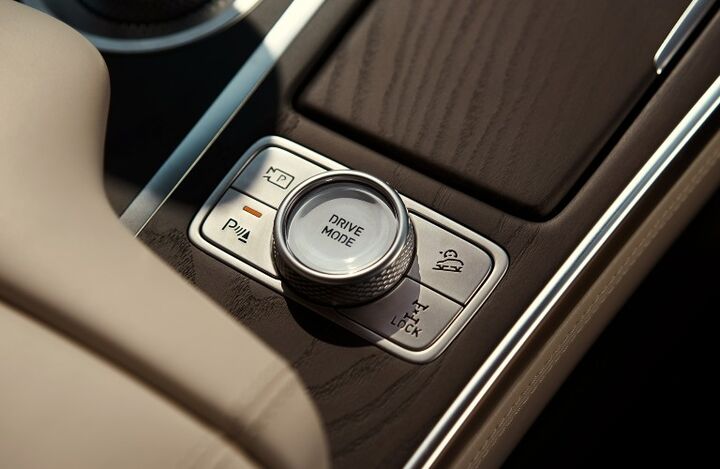 Close-up of a car's center console with a drive mode selector knob.