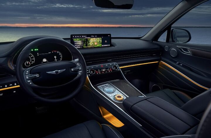Genesis GV80 interior with a large touchscreen display and ambient lighting at night.