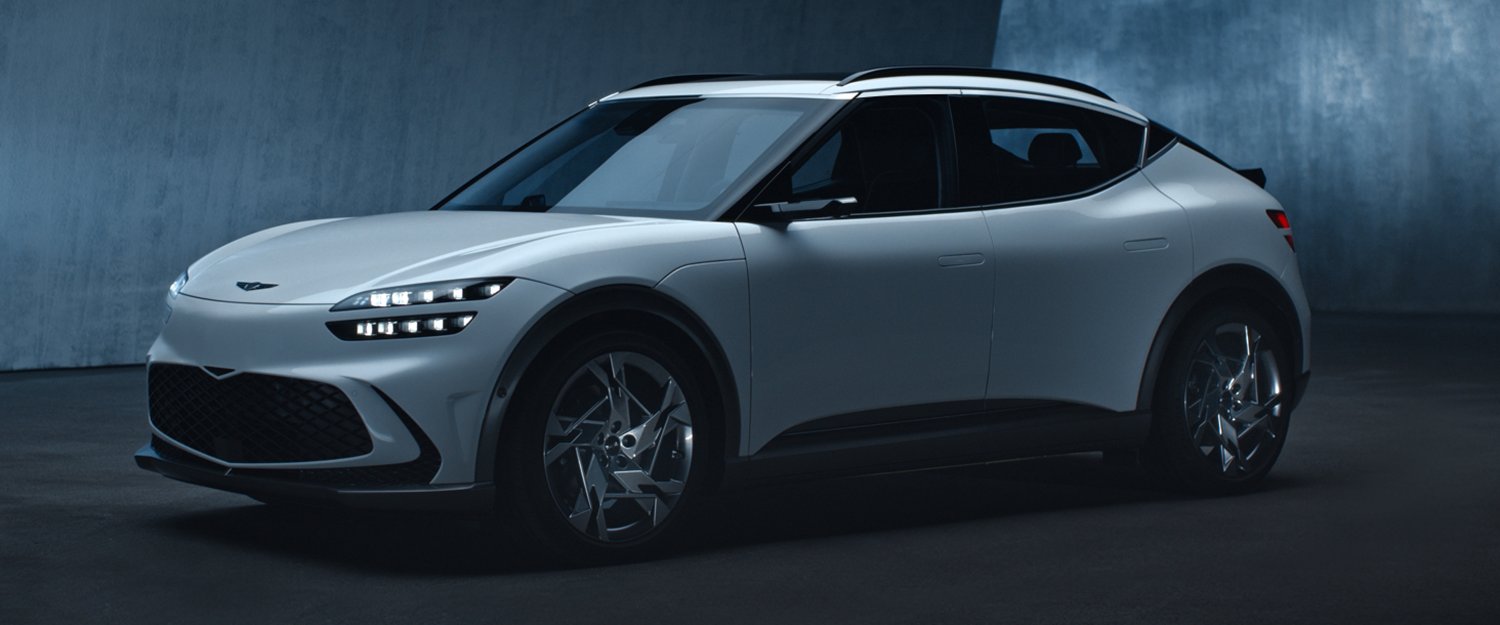 Front view of the Genesis X Speedium Coupe concept car in a dark studio.